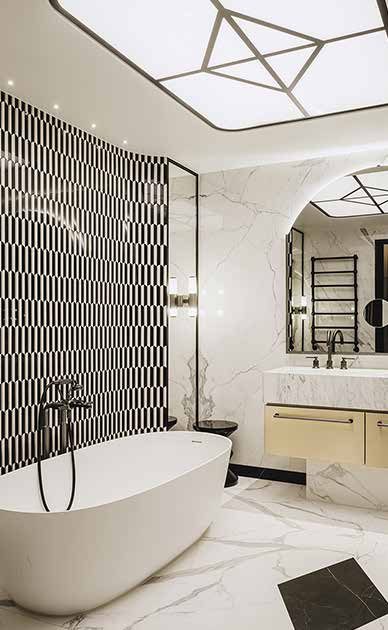 The bathroom of the bridal suite today: a freestanding bathtub, a wall with a black-and-white tile pattern, marble and a star-shaped ceiling light